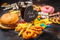 Junk food concept. Unhealthy food background. Fast food and sugar. Burger, sweets, chips, chocolate, donuts, soda Royalty Free Stock Photo