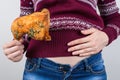 Junk food eating too much concept. Cropped close up photo of girl holding hands palm on big full abdomen feeling heartburn after Royalty Free Stock Photo