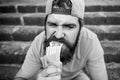 Junk food. Guy eating hot dog. Snack for good mood. Unleashed appetite. Street food concept. Man bearded eat tasty