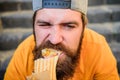 Junk food. Snack for good mood. Unleashed appetite. Street food concept. Man bearded eat tasty sausage. Urban lifestyle