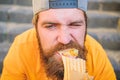 Junk food. Snack for good mood. Unleashed appetite. Street food concept. Man bearded eat tasty sausage. Urban lifestyle Royalty Free Stock Photo