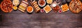 Junk food top border over a dark wood banner background Royalty Free Stock Photo