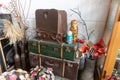 Old suitcases, nesting dolls, plastic flowers stand in a corner in an antique shop Royalty Free Stock Photo