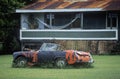 A junk sports car decaying in Hawaii