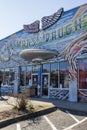 The Junkman`s Daughter store with colorful paintings on the outside of the buildings surrounded by bare winter trees