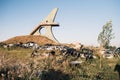 Junkyard, car dump, scrap metal. Bunch of damaged broken rusty cars overgrown with grass near the caucasus's largest