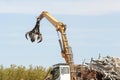 Junkyard crane with maginet moving scrap recycled steel Royalty Free Stock Photo