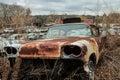 Junkyard rusty old abandoned car in car graveyard Royalty Free Stock Photo