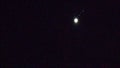 Jupiter with 4 moons, rising. In dark.