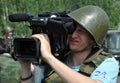 Safety first.A cameraman shoots at a military training ground.