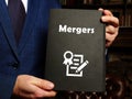 Juridical concept about Mergers with sign on the page