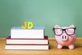 Juris Doctor law degree theme with pink piggy bank Royalty Free Stock Photo