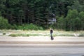 JURMALA, RIGA - AUGUST 25, 2023: Selective blur on a man on a segway on a beach, passing fast with a speed blur on a Jurmala