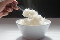 Jasmine steamed rice just finish cook, in White bowl taking with