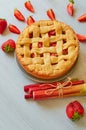 Just baked rhubarb strawberry pie on the gray kitchen background. Veggie berries tart decorated with organic fresh strawberries Royalty Free Stock Photo