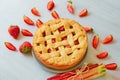 Just baked rhubarb strawberry pie on the gray kitchen background. Veggie berries tart decorated with organic fresh strawberries Royalty Free Stock Photo