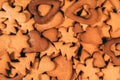 Just baked various shapes gingerbread cookies Christmas tradition background. Hearts, stars, trees, Gingerbread men are waiting