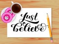 Just Believe lettering. Table with coffee. Vector illustration for card