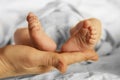 Just born baby feet in mother arms while sleeping Royalty Free Stock Photo