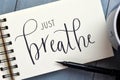 JUST BREATHE hand-lettered in notepad with brush pen Royalty Free Stock Photo