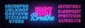 Just Breathe neon lettering on brick wall background.