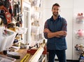 Just call me Mr Fixit. Portrait of a handsome young handyman standing in front of his work tools.