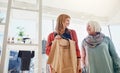 We just cant resist a bargain. a mother and daughter shopping in a clothing boutique.