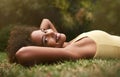 Just chillin. Portrait of a happy young woman lying on the grass.