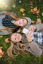 Just chilling with my bestie. High angle shot of two happy teenagers relaxing together on the grass outside.