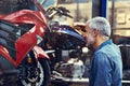 He just couldnt walk by without a peek. a mature man admiring the window display of a motorcycle shop. Royalty Free Stock Photo