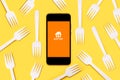Just eat application icon on black screen of smartphone with white plastic forks Royalty Free Stock Photo