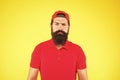 Just fabulous hair. sad mature hipster yellow background. bearded man red shirt and cap. male summer fashion. Barber Royalty Free Stock Photo