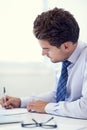 Just finishing up some paperwork. a young businessman working in his office.