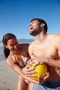 Just a friendly game. a happy couple playing with a ball together on a beach. Royalty Free Stock Photo