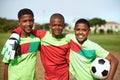 Just give us a ball and well be happy. Portrait of a group of young boys playing soccer on a sports field. Royalty Free Stock Photo