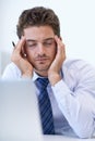 This just gives me one BIG headache. a stressed businessman holding his hands to his head. Royalty Free Stock Photo