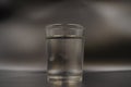Just a glass of water on a dark wooden table. Mineral water in a glass on a black background. A glass with water Royalty Free Stock Photo