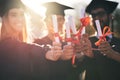 Just graduated. a group of students holding their diplomas together on graduation day. Royalty Free Stock Photo