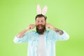 Just grow your hair. Bearded man wear bunny ears green background. Hipster with facial hair in Easter style. Handlebar