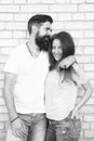 Just hang out together. Couple in love. Family couple hugging on brick wall background. Bearded man and sexy woman