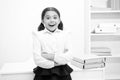 Just heard excellent news. Child girl wears school uniform standing excited face expression. Schoolgirl smart child