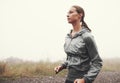 Just her and the road this morning. A young woman jogging on a country road on a misty morning.