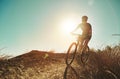 Just imagine what a ride will do for your well-being. a man out cycling in the countryside.