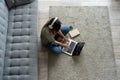 Just inspired. Confident young beautiful smiling woman working on laptop while sitting on the floor at home. Royalty Free Stock Photo