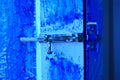 Just an iron lock on the door a blue bolt Royalty Free Stock Photo