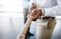 Just keep pulling once success is within your grasp. an unrecognizable businessman pulling on a rope during tug of war. Royalty Free Stock Photo