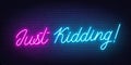 Just Kidding neon lettering on brick wall background Royalty Free Stock Photo