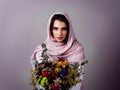 Just like the flowers her beauty grows every time. Studio portrait of a confident young woman wearing a colorful head Royalty Free Stock Photo