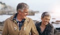Just like the good old days. a beautiful elderly couple taking a walk at the beach. Royalty Free Stock Photo
