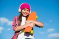 Just a little more plastic underfoot. Happy skater on blue sky. Small kid hold penny board. Riding penny skateboard Royalty Free Stock Photo